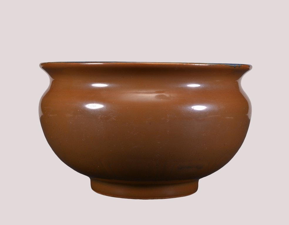 A CAFÉ'-AU-LAIT GLAZED BOWL: The bowl is concave-shaped and overall a brown color tone. Ming Dynasty 4 11/16 in. (11.9 cm) tall, 7 11/16 in. (19.5 cm) diameter.