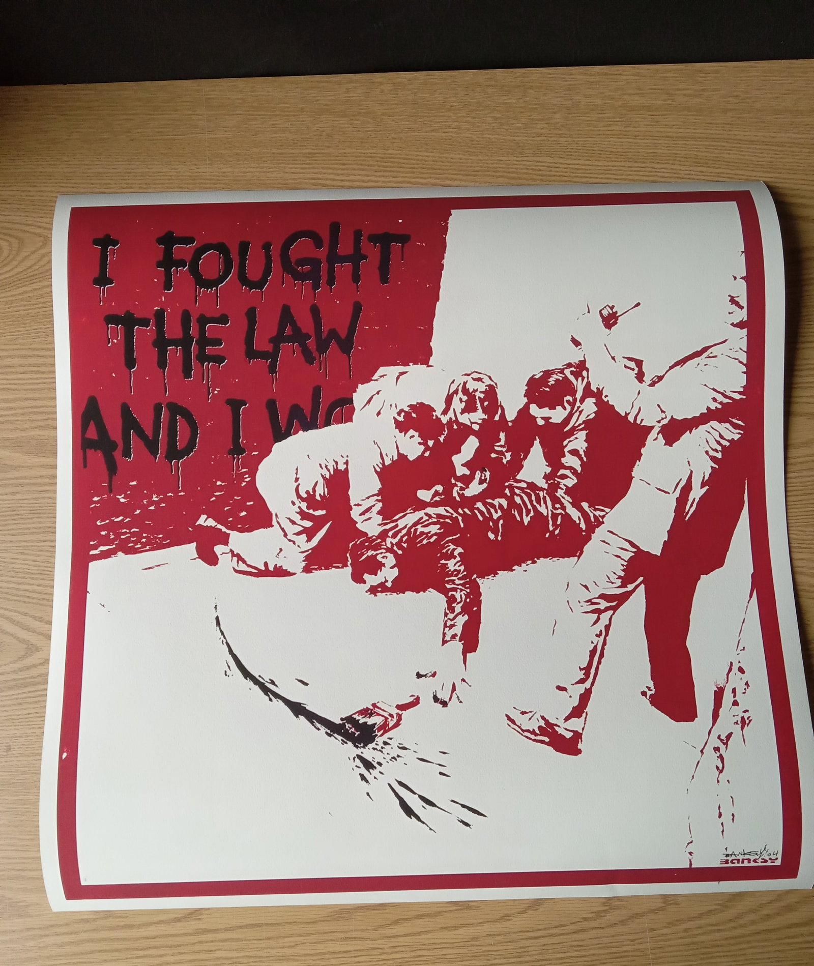 Banksy "I Fought the Law" Print (Red and Black) Sold After: Banksy "I Fought the Law" Print in red and black on heavy wove paper - Measures 26 1/8 X 26 Inches. These items are part of an estate sale and we are a consignment based Auction House. All auction