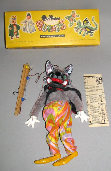 NMIB PELHAM PUPPET WOLF: 1960s composition Wolf marionette with psychedelic pants. Puppet has never been played with. Complete with instructions. Box excellent to near mint. Wolf is 13 1/2 inches tall. Size: 37" tall, 8" wide
