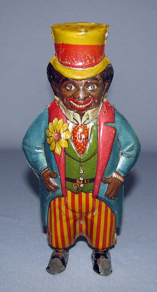 GERMAN TIN LITHO BLACK DUDE: 1920s wind up toy, works fine. Brightly lithographed toy has scattered minor surface wear. Some paint loss to feet. Size: 7" tall