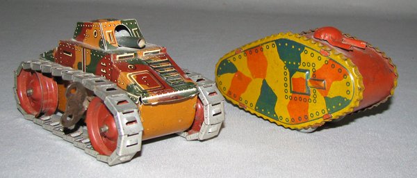 TWO TIN WINDUP TANKS: Prewar Japanese camouflage tank by CK and an unmarked German tank, probably by Arnold. Both working, some scattered scratching Size: 3 3/4" long