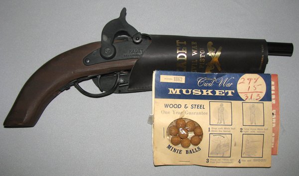 UNUSED MODEL 1862 CIVIL WAR TOY PISTOL WITH BOOK A: Made in 1965 for the Centennial of the Civil War by Kadets International, Savannah, Tennessee. Original deluxe naugahyde holster still has the carded mini balls and a little booklet from Kadets of Ame