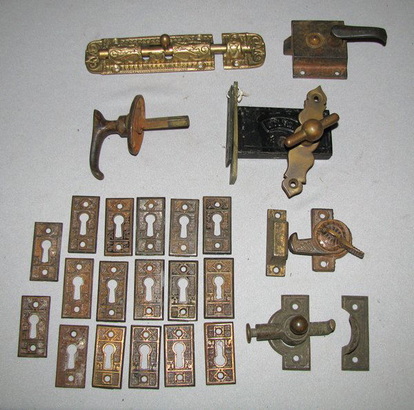 ASSORTMENT OF VICTORIAN LOCKS AND KEY PLATES: 28 pieces including two fancy window locks, interior door locked marked BLW, and a large group of brass trimmed cast iron lock plates. Size: sizes vary