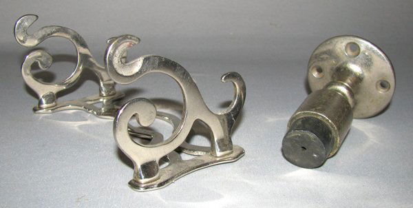 VICTORIAN TOILET PAPER HOLDER AND DOORSTOP: Nickeled brass toilet paper holder by Art Brass Company. Very minor wear. Unsigned nickeled brass door bumper with original rubber. Some wear to finish. Size: Largest is 6" long by 2 3/4" deep