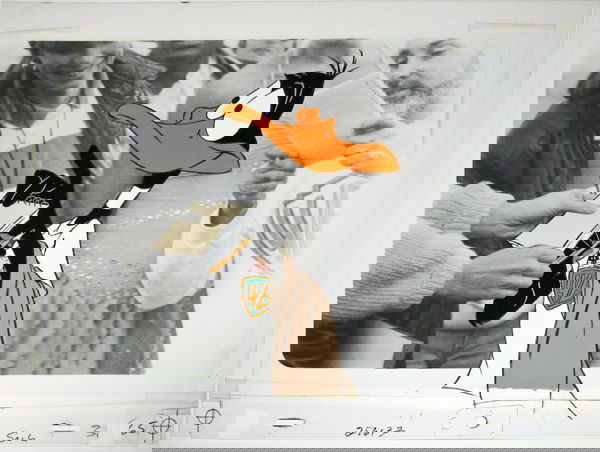 ORIGINAL WARNER BROS. DAFFY DUCK ANIMATION CEL: Cel is mounted on a black and white photographic background and shows Daffy wearing a Warner Bros. t-shirt and signing autographs. Cel is marked 256132, SC6 and 65. Bottom edge of cel has tape repair.
