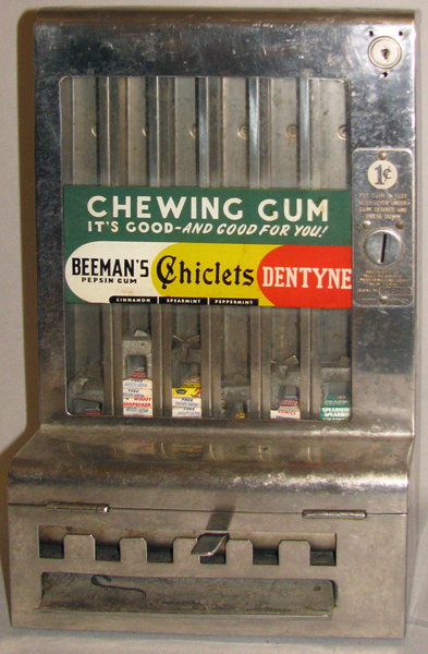 MILLS AUTOMATIC GUM MACHINE: 1936 stainless steel vendor in working condition. There is no key and the lock is not original but it is not locked so inside is accessible. The front decal is probably a replacement. Couple of small 