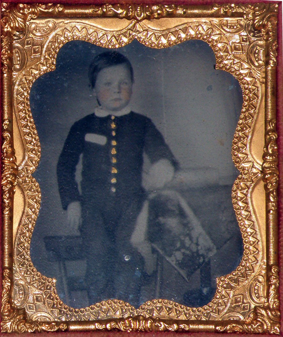 CASED 1/6 PLATE AMBROTYPE OF A LITTLE BOY: Pink cheeked child with hand painted gold buttons on his outfit, in embossed leather case, case has minor wear.