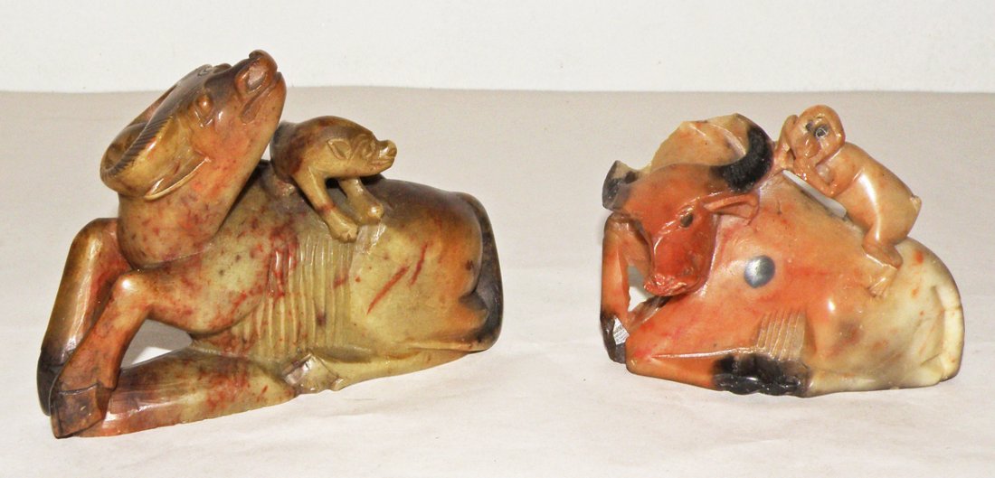 TWO SOAPSTONE WATER BUFFALOES: Both figures have animals on their backs. Smallest has damage to horns. Size: Largest: 4 1/4"