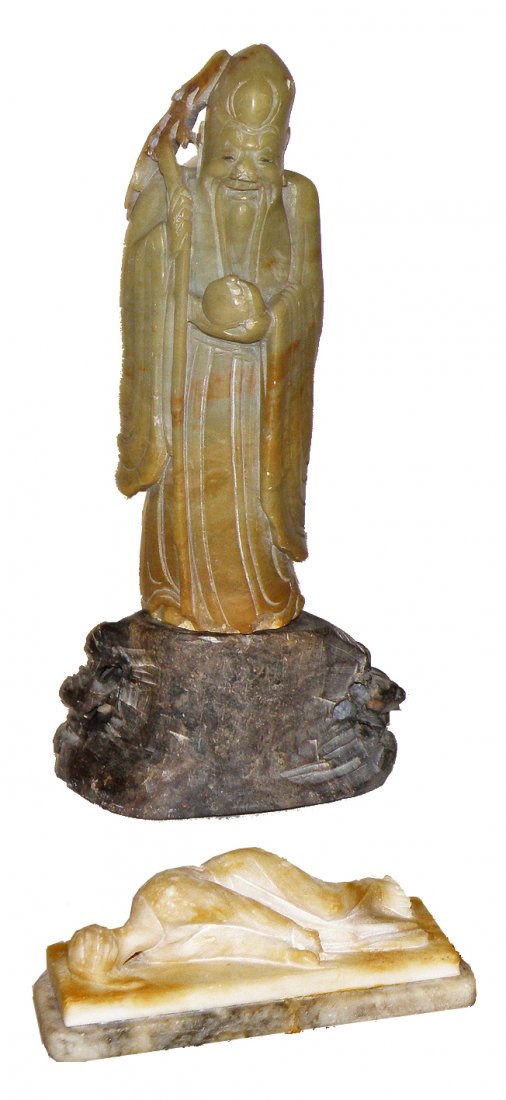 TWO SOAPSTONE CARVED PEOPLE: One Chinese, the other probably from India. Chinese figure is of an elderly man with a cane, seperate carved soap stone base. India figure of reclining man, damage to base. Size: Largest: 8 1/4"