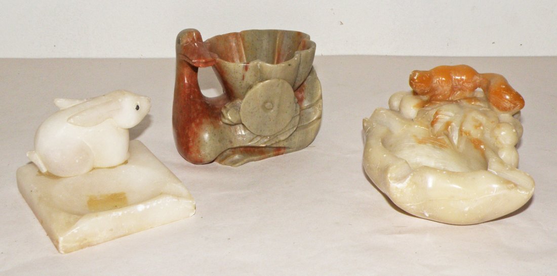 THREE CARVED SOAPSTONE ITEMS WITH ANIMALS: Ashtray with a rabbit, ashtray with squirrel and small bowl with a swan. Size: Largest: 4 1/4"