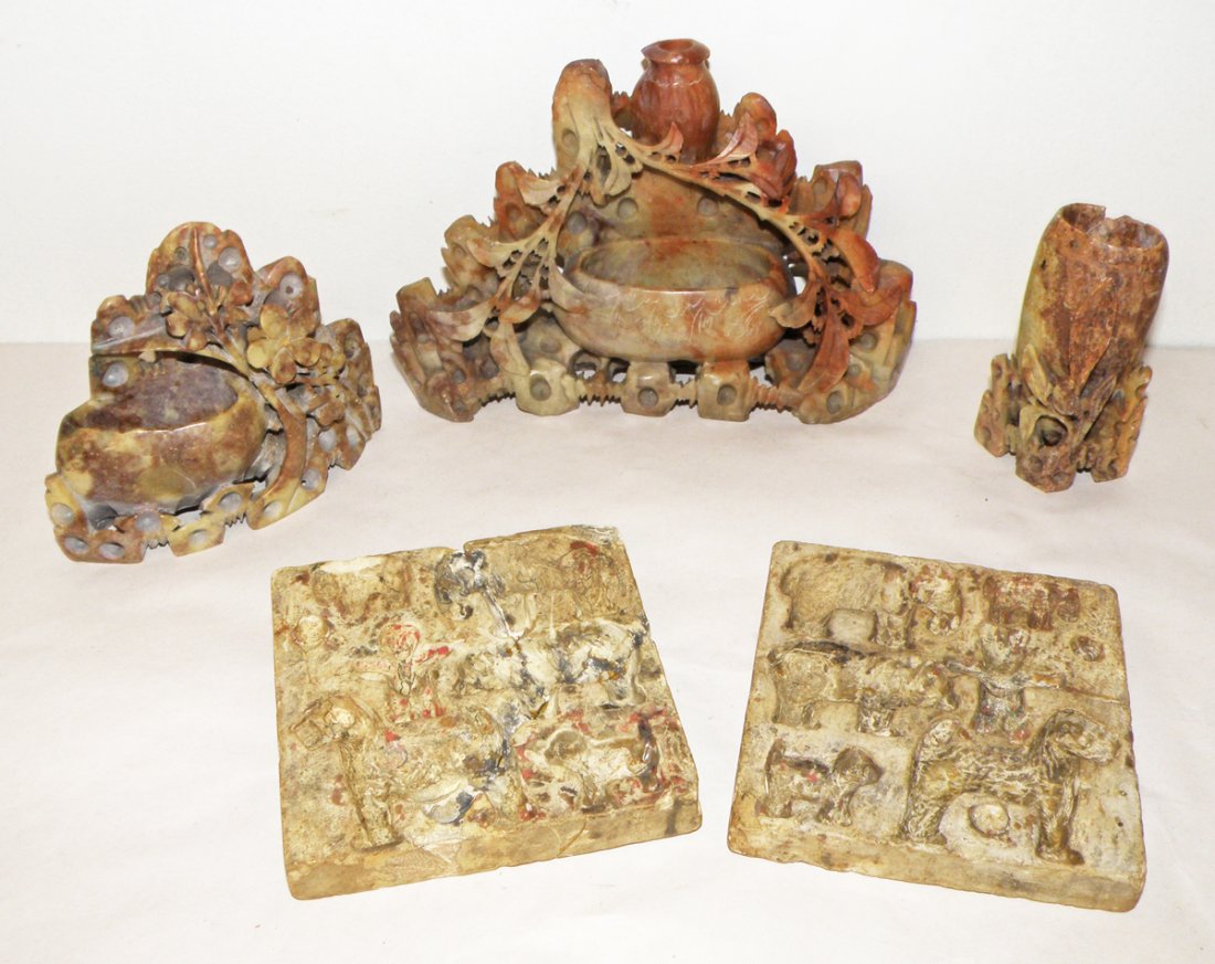 FOUR PIECES OF CARVED SOAPSTONE: Including a mold for including childs play figures. Mold repaired. Three vases with carved vines. Smaller vase has chip to edge. Size: Largest: 6 3/4"