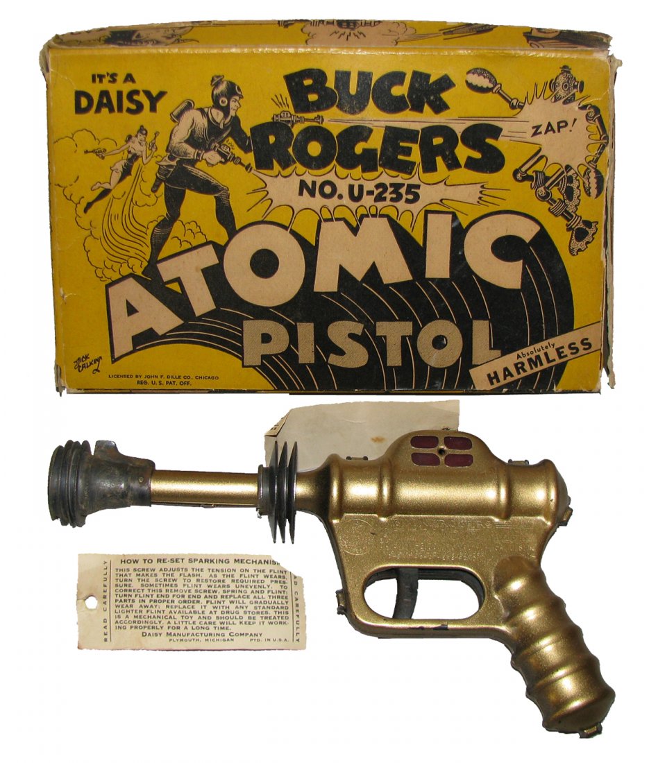 BOXED DAISY BUCK ROGERS U-235 ATOMIC PISTOL: C-1935 Buck Rogers pistol works fine, needs new flint for spark. This is the gold anodized version. Toy comes with original instruction tag. Box has two inner flaps detached and retaped on one end. Ou