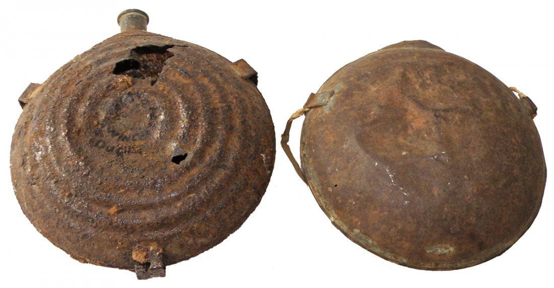 TWO DUG CIVIL WAR CANTEENS: M1858 smooth side missing spout. A bullseye canteen made by Porter Hayden and Booth, Philadelphia. Marked dug at Winchester. Size: Largest: 7 3/4" diam.