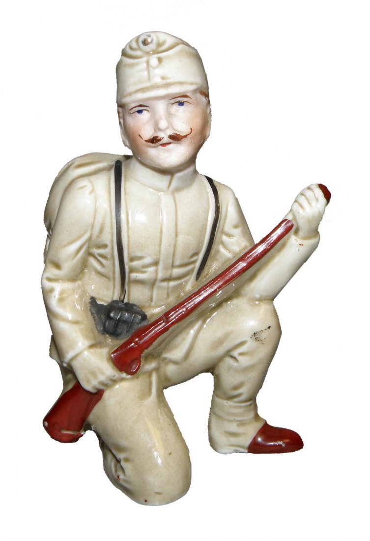 KNEELING PORCELAIN SOLDIER STILL BANK: Austrian C-1910, incised number 1809 on back. Ref. One Hundred Years of Ceramic Money Banks, by Beth Baddeley Huebner, Vol. 1, Plate 662, Rarity C. Size: 3-5/8" tall, 2-1/2" wide