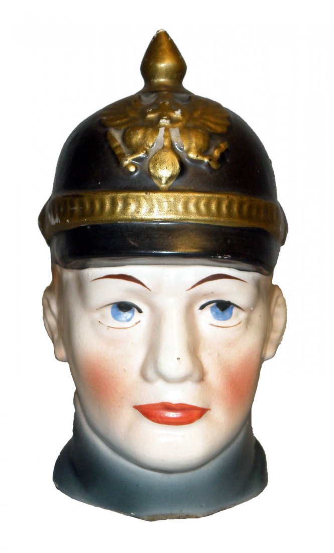 PRUSSIAN SOLDIER BUST CERAMIC STILL BANK: Prussian soldier wearing Pickelhaube, minor paint wear to gold details. Ref. One Hundred Years of Ceramic Money Banks, by Beth Baddeley Huebner, Vol. 2, Plate 85, Rarity D. Size: 6" tall