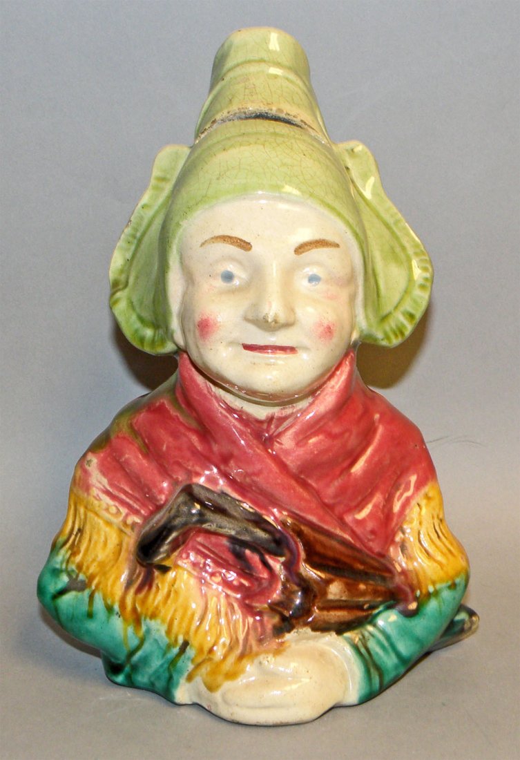 CAPE BRETON WOMAN CERAMIC STILL BANK: Made by Francis Masse, Nord Pas de Calais, C-1930. Some crazing to glaze, small wear spot on tip of nose. Ref. One Hundred Years of Ceramic Money Banks, Vol. 2, Plate172, Rarity E. Size: 8-1/4" tall, 