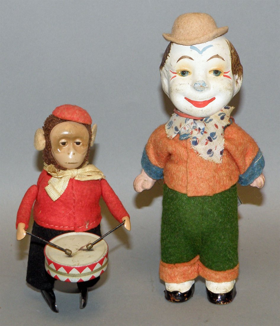 TWO GERMAN WINDUP TOYS: Schuco drumming monkey and a papier mache dancing clown. Both toys work fine, minor wear. Size: Tallest 6-1/2"