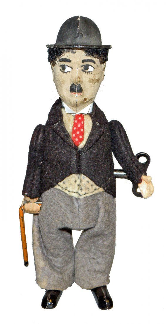 SCHUCO CHARLIE CHAPLIN: Tin windup works fine, a couple of abrasions to face and minor paint chipping to hat. Size: 6-1/2" tall