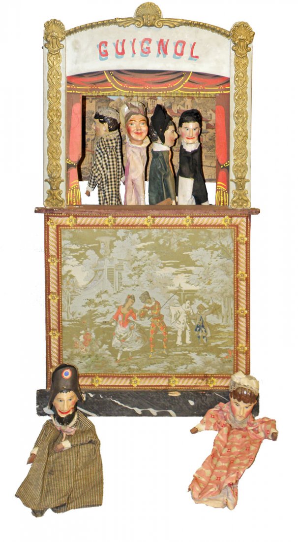 GUIGNOL TOY THEATRE: Late 19th century French puppet theatre complete with six original puppets, roll up curtain and nicely gessoed decorated stage. Composition headed puppets have some scattered wear to heads and paint, 