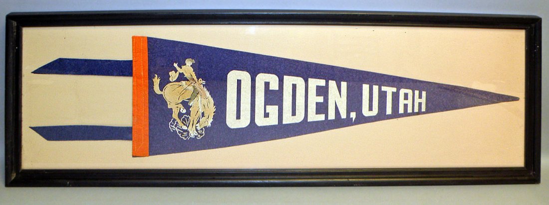 FRAMED OGDEN UTAH PENANT: Thirties pennant with image of bronco riding cowboy. Slight fading to blue. Sight size is 35 inches by nine inches. Size: 37-3/4" x 12-3/4"
