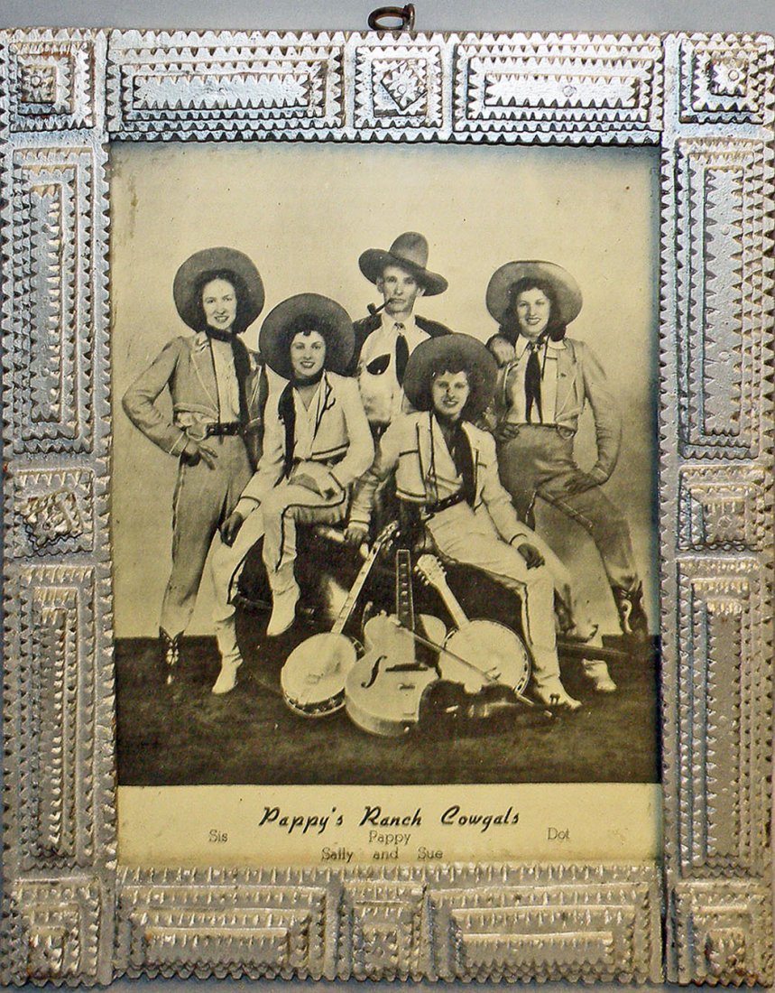 TRAMP ART FRAME WITH COUNTRY BAND PHOTO: Carved and painted wood frame has publicity photograph of Pappy's Ranch Cowgal's. Light paint wear. Size: 12-1/4" x 10-1/8"