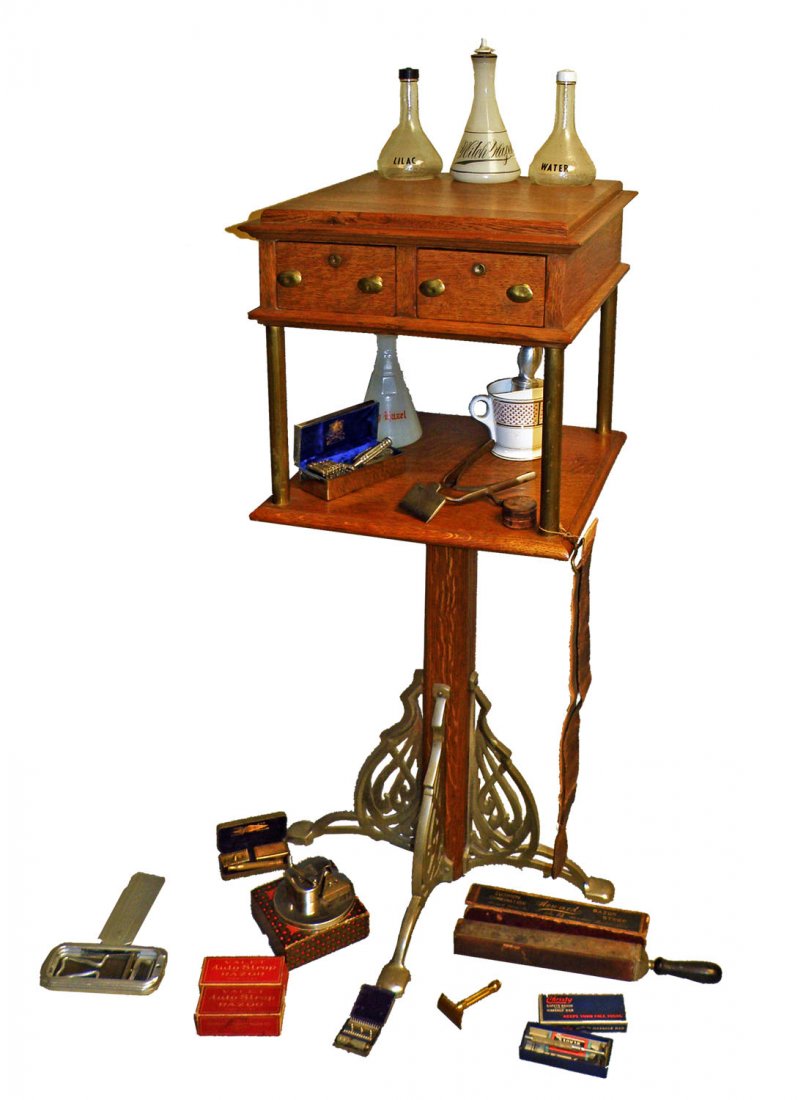 OAK BARBER STAND WITH EXTENSIVE CONTENTS: C-1915; oak two-drawer stand with nickel plated iron feet. Came from a long ago closed Washington D.C. barbershop. Stand has been refinished and is unmarked, but certainly from a quality manufacturer.