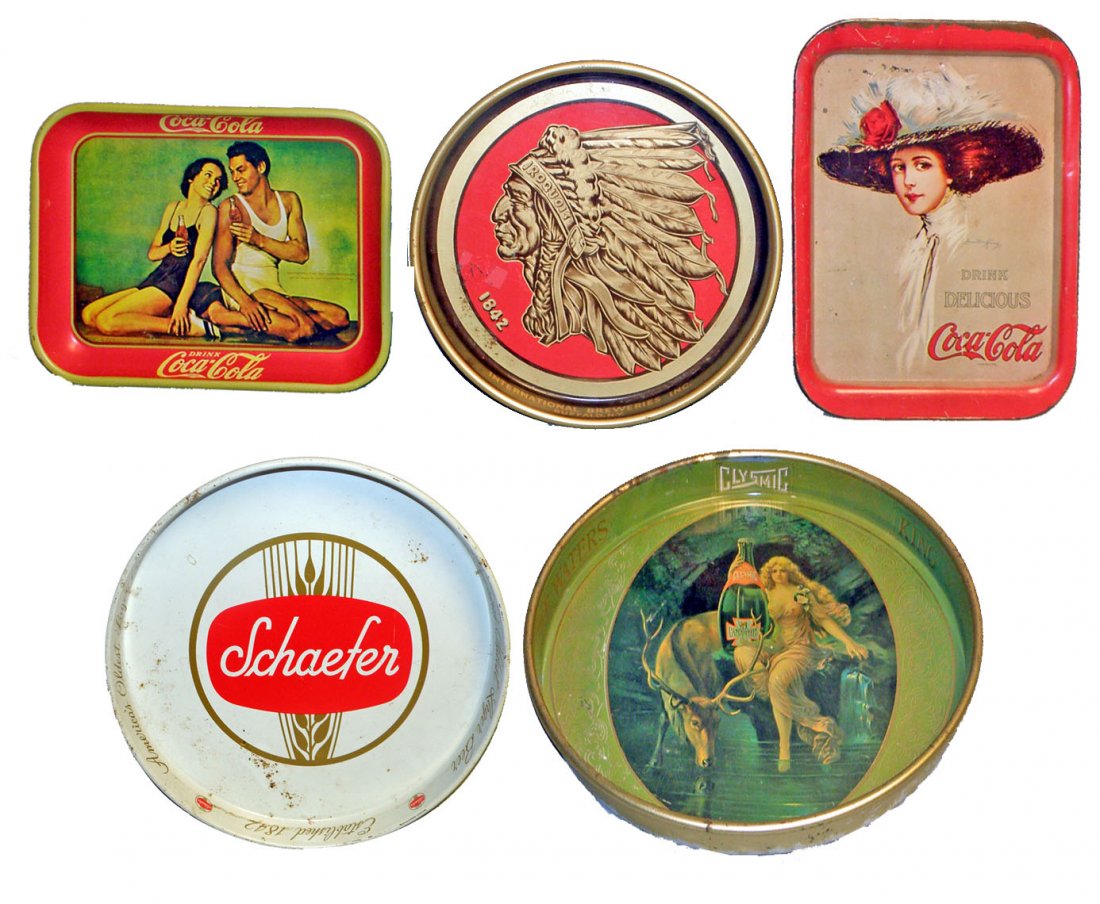 FIVE ADVERTISING TRAYS: Schaefer Beer, Iroquois Beer, Clysmic Water, and two Coca-Cola reproduction trays. Ages and conditions vary. Size: Largest 14-1/2" long