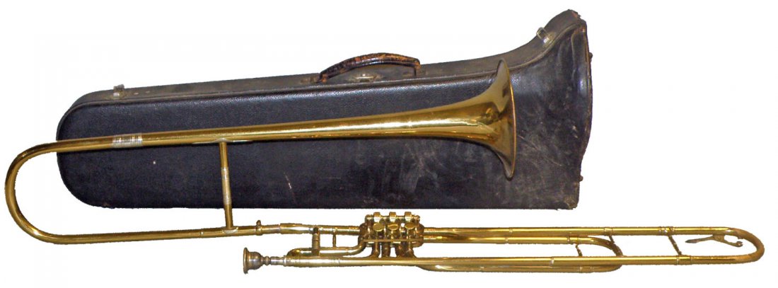 ROTARY VALVE TROMBONE IN ORIGINAL CASE: Made by Alberg & Ohlsson. Complete and working. All valves are free and functioning. Minor wear to brass and a few small scattered dings. Bell also marked with No. 73. Case length 33". Case shows some