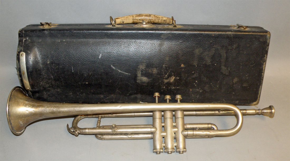 TRUMPET IN ORIGINAL CASE: Nickel plated brass made by Continental Clarion. All valves free and working. Some scattered dings to metal. Original case is Good. Size: 20-1/2" long
