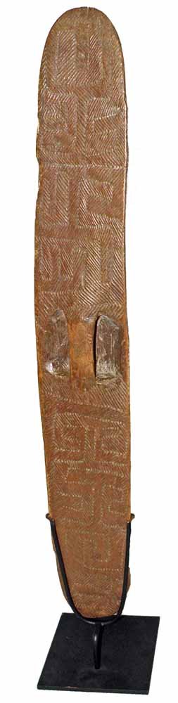 AUSTRALIAN ABORIGINAL SHIELD: 19th century with geometric carved decorations. Museum style stand. Minor edge wear. Provenance: Dirk Hudig Collection, New Zealand, 1960s. Size: 26 3/4" tall, 4" wide