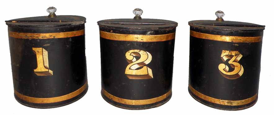 THREE TOLE PAINTED CANISTERS: Nicely decorated tin kitchen canisters with original glass knobs. Numbered 1, 2, and 3. Some scattered paint chipping and surface wear. Size: 8 1/4" diameter, 9" tall