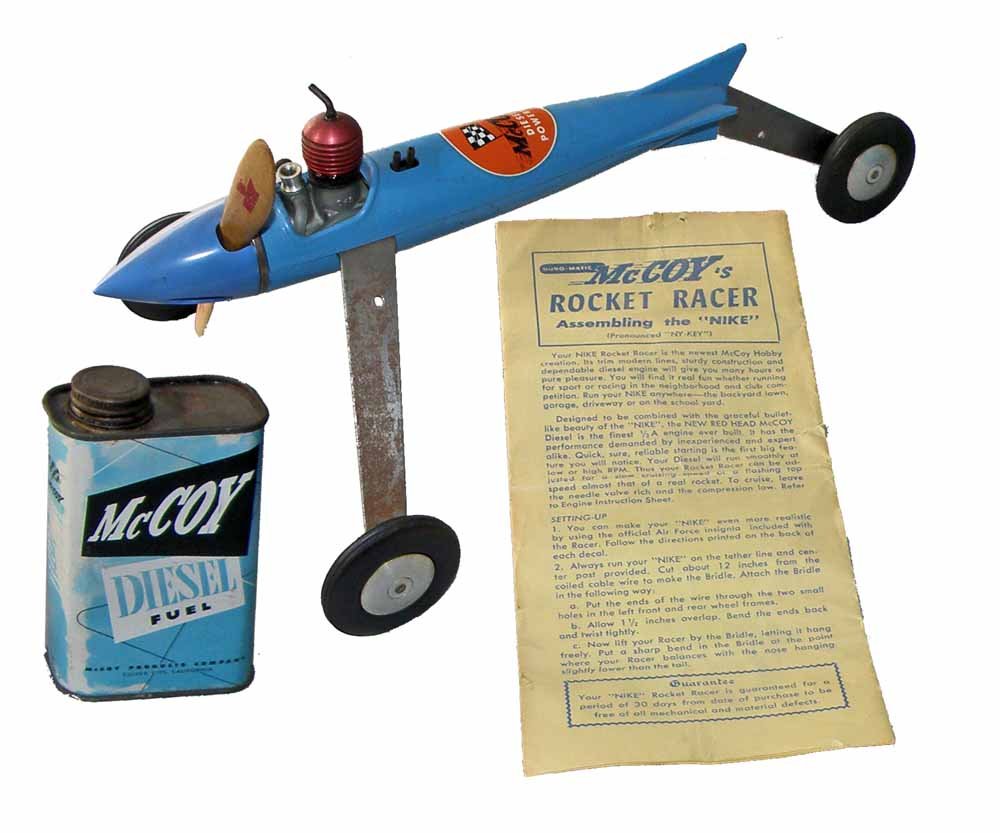 McCOY NIKE ROCKET RACER: Scarce diesel powered tether racer appears to be unused. Comes with rare original instructions and an empty fuel can. Minor aging to plated parts. 13" long