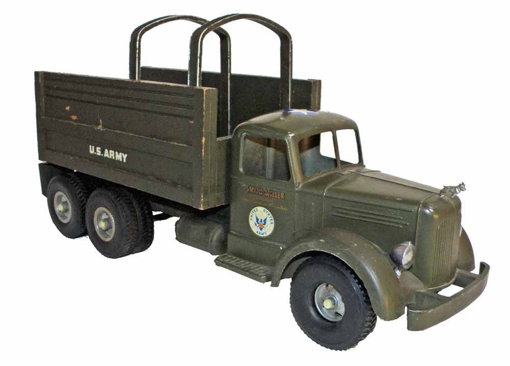 SMITH MILLER MACK ARMY TRUCK: Headlights, bumper, and ornament are intact. Retains original hoops in bed. Scattered minor paint wear. 19" long