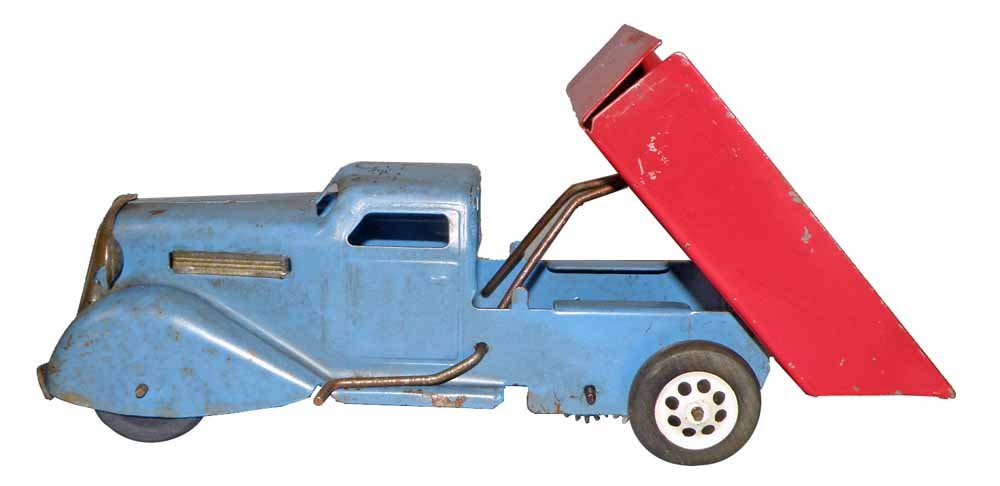 WYNDOTTE WINDUP DUMP TRUCK: 1930's pressed steel truck with working motor. Scattered paint chipping and wear. 11" long