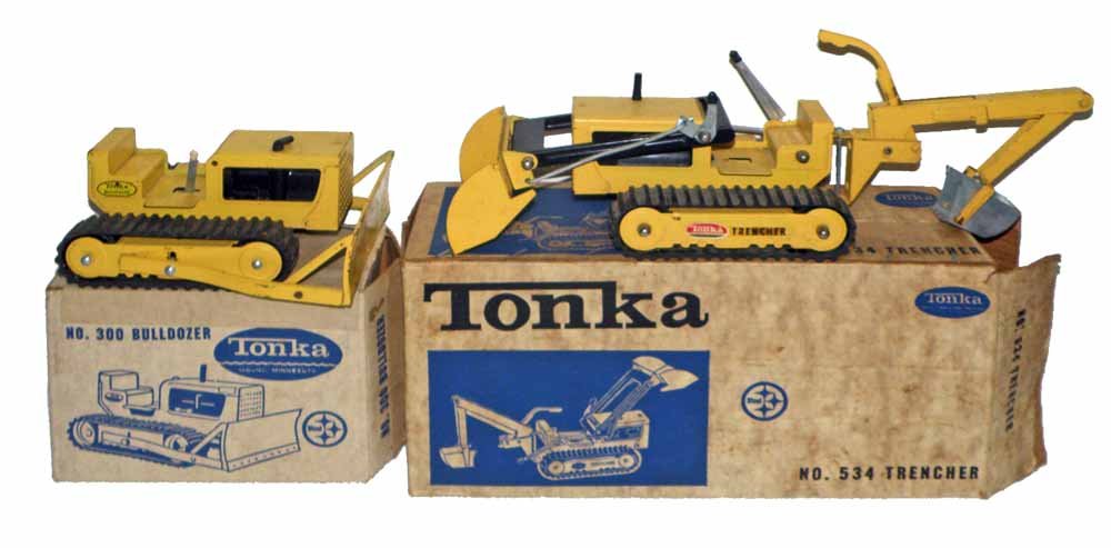 TWO BOXED TONKA CONSTRUCTION TOYS: No 534 trencher and No. 300 bulldozer. Both toys complete showing play wear. Both boxes are complete and VG-Fine. Largest 19 1/2"