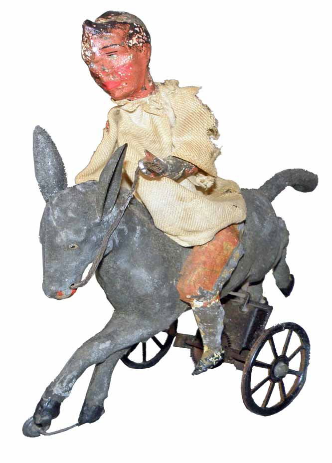 GUNTHERMANN CLOWN ON DONKEY: Hand painted tin and cloth toy, works fine. Original cloth shirt has wear, especially to sleeves. Overall paint wear. Reigns replaced. 9" long x 9" tall