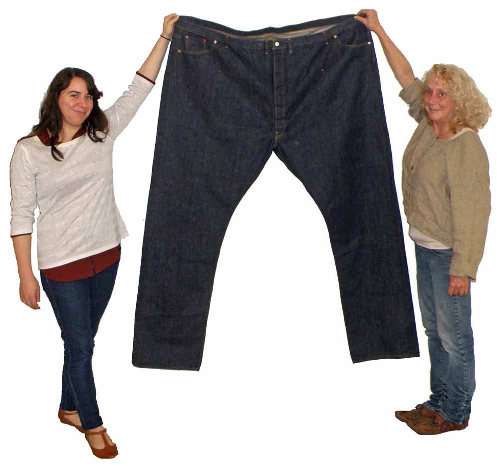 LEVI 501 BIG E RED LINE STORE DISPLAY JEANS: Oversized pair of button fly Levi jeans. C-1960. Missing leather tab at back. 72 inch waist and 43 inch inseam. Fully riveted with watch pocket. 61" tall