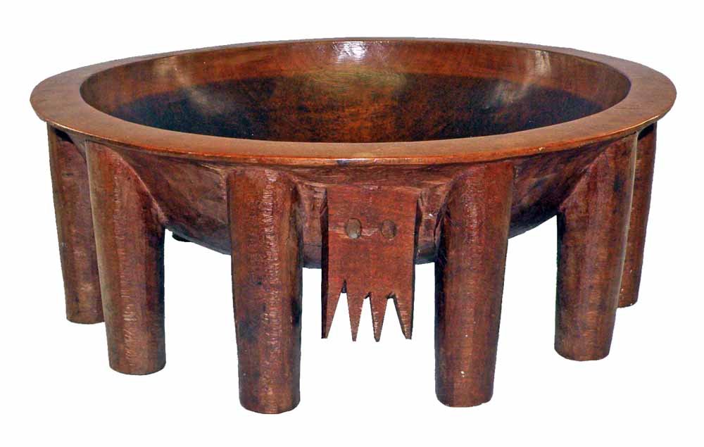 19th CENTURY FEAST BOWL FROM SAMOA: Carved from one piece of wood with twelve legs and traditional animal face. Beautifully polished interior with kava residue. 21" diameter, 8" tall