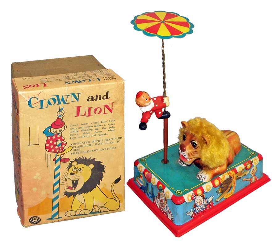 BOXED BATT-OP CLOWN AND LION: From Masudaya. Toy works fine. Base is dirty but will clean. Original box is complete but has some creasing and one split corner to lid. Box grades very good. 8-3/4" long, 13" tall