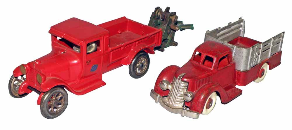 TWO CAST IRON TOY TRUCKS: An arcade Red Baby, repainted, with broken original tow boom. And a Hubley ten ton Stake body truck with replaced grill and tires. Over paint to body. Largest 8-1/2"