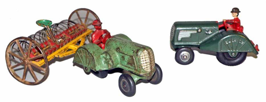 TWO CAST IRON OLIVER TRACTORS AND HAY RAKE: Arcade hay rake has some bend to tines. One tractor appears to be repainted. Largest is 7" wide