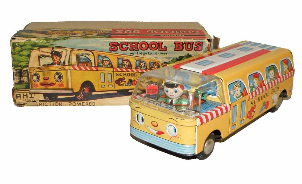 BOXED JAPANESE TIN SCHOOL BUS: Made by AHI, lithographed toy with moving driver and moving face on bus. Very minor play wear. Original box lid torn and needs repair. Box grades fair to good. 8-3/4" long