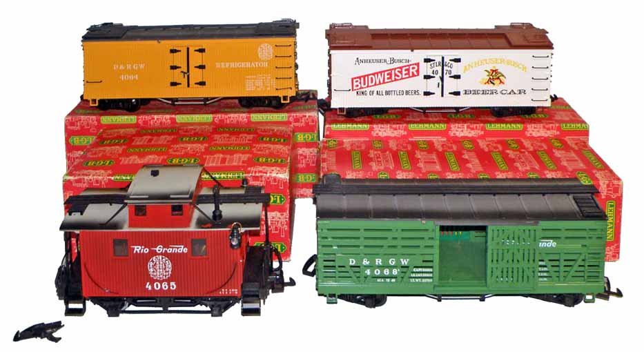 FOUR BOXED LGB TRAIN CARS: A 4064 Denver & Rio Grande Western refrigerator car, a 4065 Rio Grande Caboose, a 4068 Denver & Rio Grande Western cattle car and a 4070 Budweiser freight car. Boxes are complete and grade very fine. 