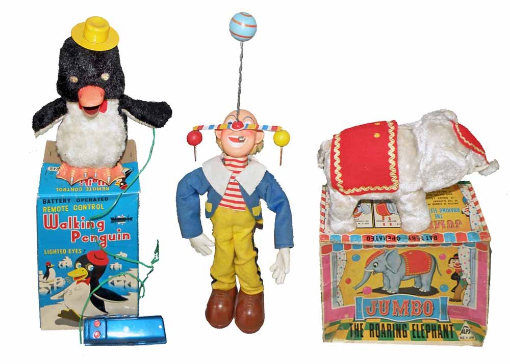 THREE BATTERY OPERATED CIRCUS TOYS: Pinky the Clown not working. Boxed Walking Penguin by Masudaya. Eyes light up but does not walk. Boxed Jumbo Roaring Elephant not working. Boxes Good - Fine.Largest 23"Tall