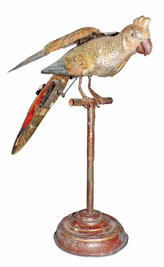 GUNTHERMANN WIND-UP PARROT ON STAND: Toy works but needs oil. Hand painted parrot and stand with lithographed tail. Wear to painted surface. Some scratching to litho.11" Tall x 10" Long