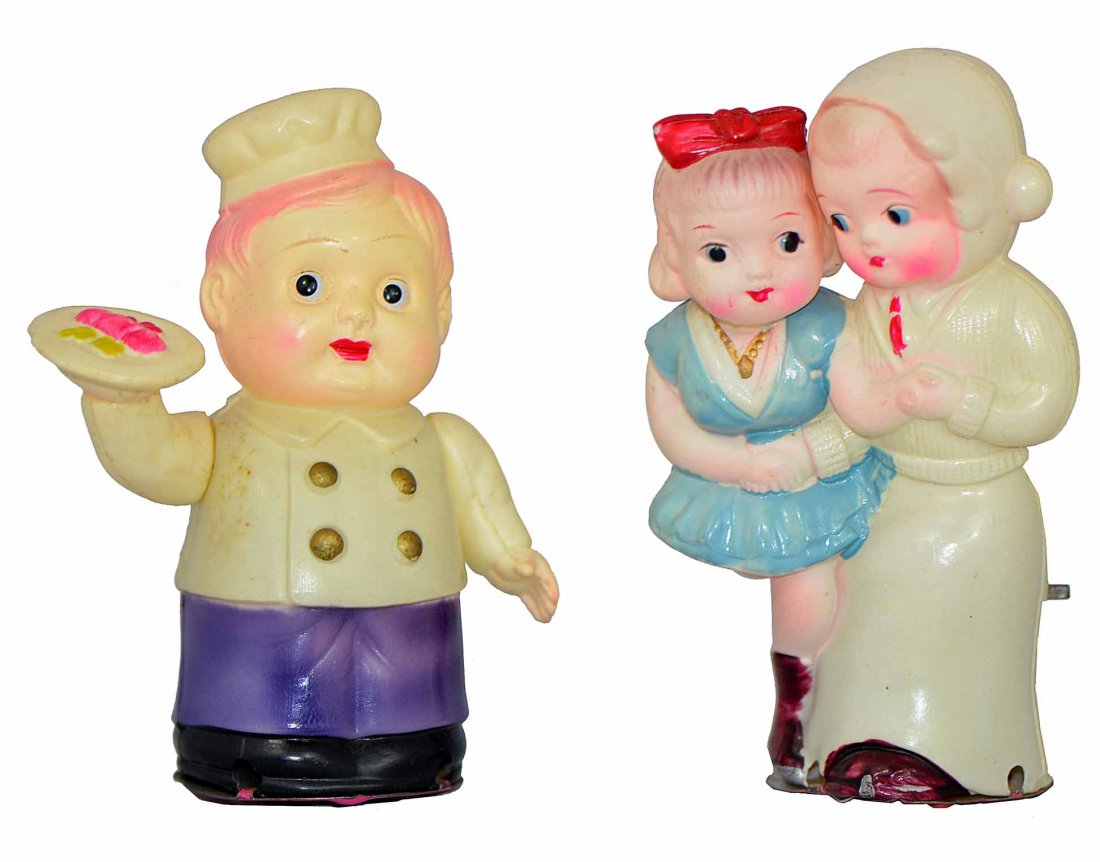 TWO OCCUPIED JAPAN CELLULOID TOYS: Cheery Cook and Skating Couple. Both work fine. Skating boy has small ding to head.5 1/4" Tall