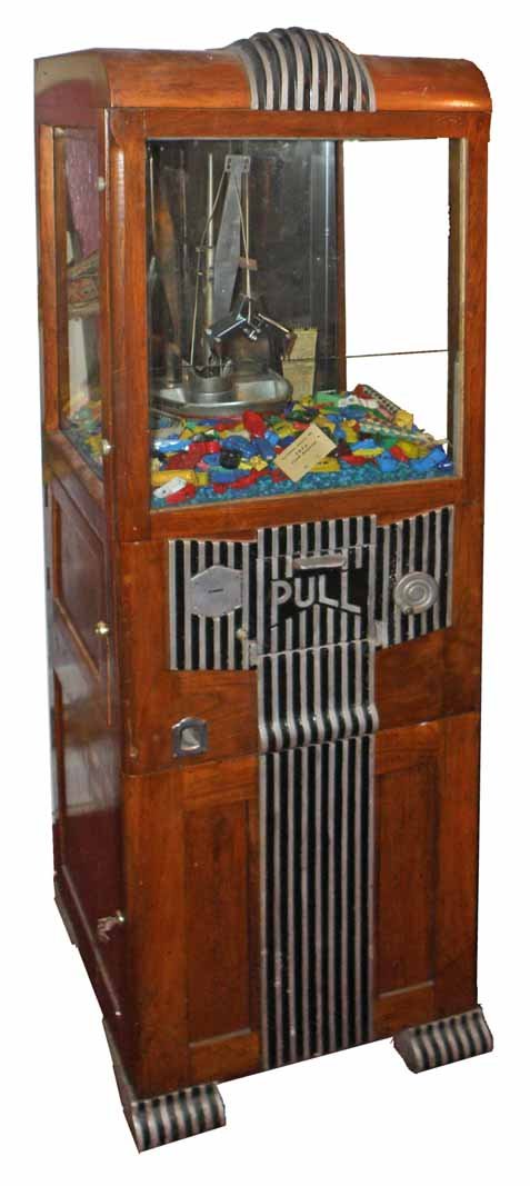 NOVELTY MERCHANT MAN DIGGER BY EXIBIT SUPPLY COMPANY: Working machine from Rehoboth Beach, Delaware. Originally owned by Maryland Novelty Company. Has some replaced locks and keys. Some wear to case.72" Tall x 21 1/2" Wide x 21" Deep