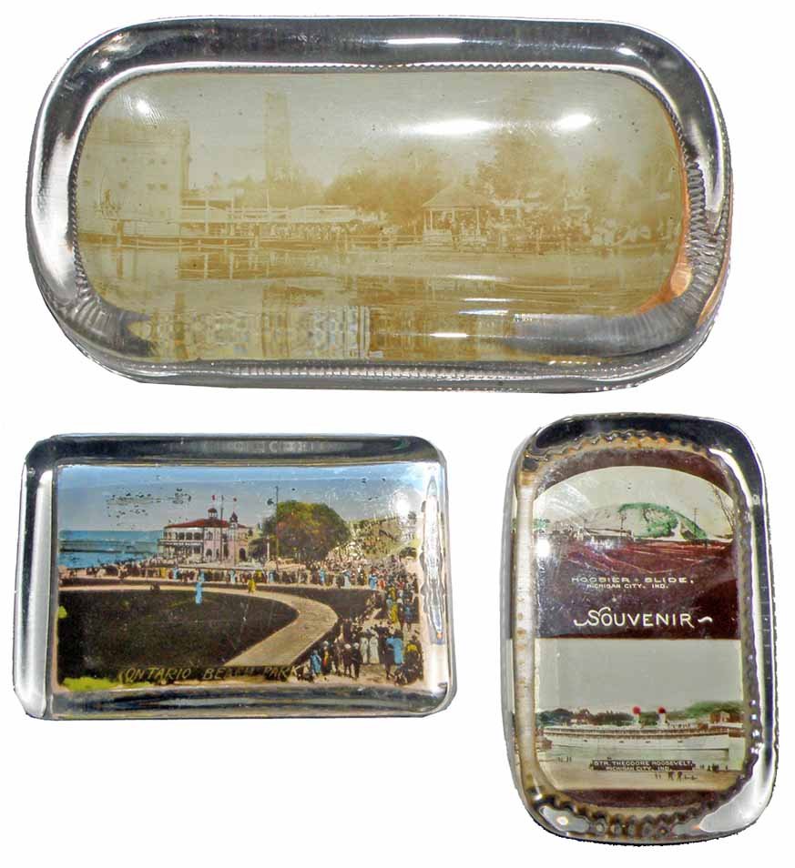 THREE GLASS STEAMSHIP PAPER WEIGHTS: Pin tray from Celeron Amusement Park, Ontario Beach Park, and The Theodore Roosevelt / Hooiser Slide.Largest 7 1/4" Long