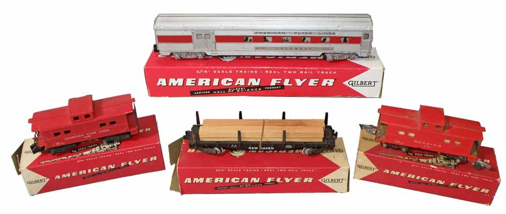 THREE BOXED AMERICAN FLYER TRAIN CARS: #24603 Caboose (crack to body), #630 Caboose, #928 Lumber Car, #960 Columbus Passenger Car, some boxes are incomplete and or show wear. Boxes grade Fair to Fine. Cars show some play wear.Largest 13 1/