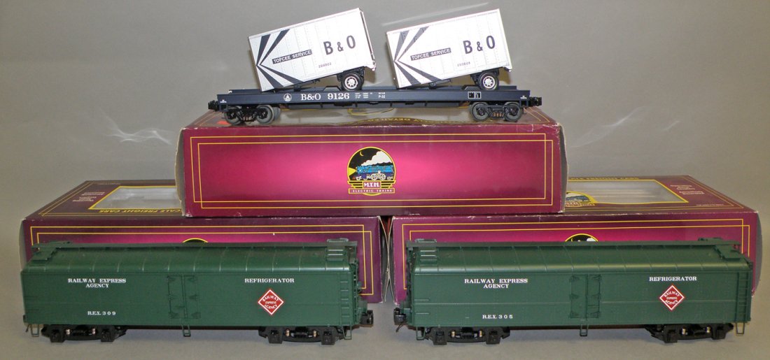 THREE BOXED MTH FRIEGHT CARS: Unused O Scale, #20-94075 REA Reefer, #20-94136 REA Reefer, and #20-98110 B&O Flat car. Size: 14 1/2" long